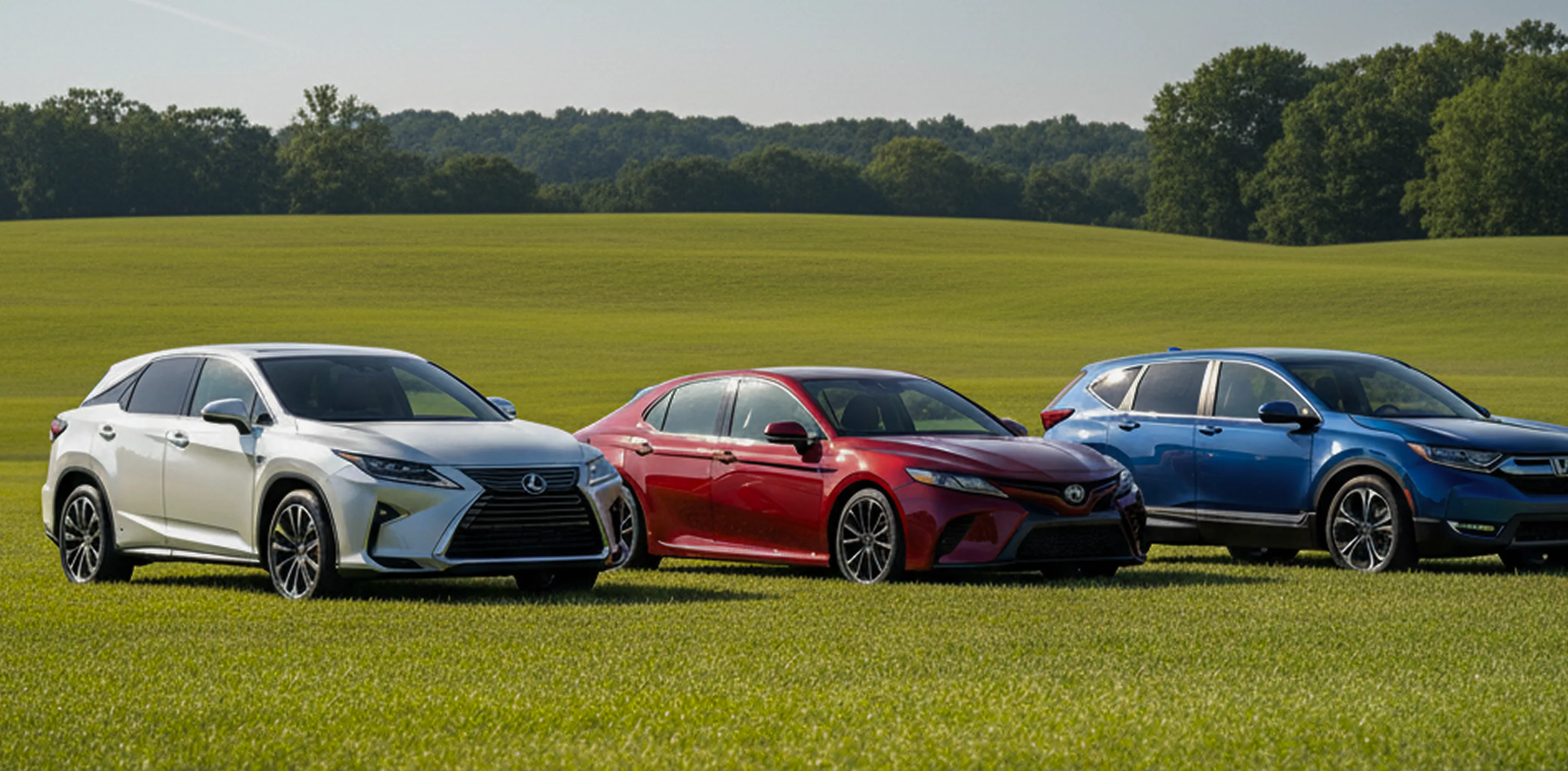 Cars parked on an open field